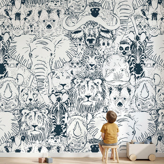 Full wall African animal mural in a kids' playroom featuring seamless elephants, giraffes, zebras, and white design elements.