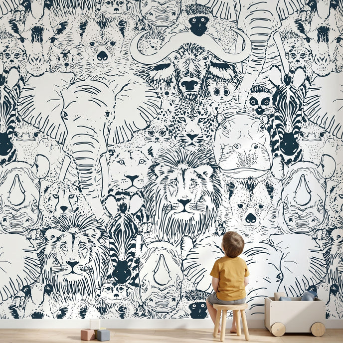 Full wall African animal mural in a kids' playroom featuring seamless elephants, giraffes, zebras, and white design elements.