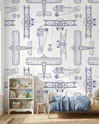 Kids' room with a white seamless mural featuring subtle plane patterns, illuminated by natural daylight, creating a balanced and vibrant space.