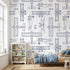 Kids' room with a white seamless mural featuring subtle plane patterns, illuminated by natural daylight, creating a balanced and vibrant space.