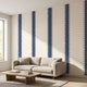 Expansive view of a mural covering an entire wall in a minimalist space with natural lighting, emphasizing vibrant geometric pattern.