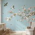 Vibrant chinoiserie-inspired floral mural with cherry blossoms and birds, perfect for a sophisticated nursery wall decor.