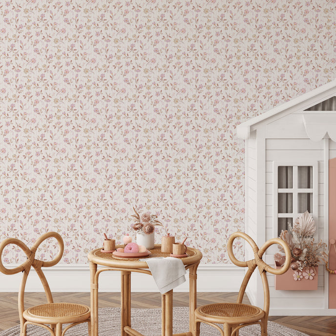 A styled interior scene featuring a
soft pink and neutral floral wallpaper with delicate flowers and leafy sprigs on a subtle striped background., with a small wooden table, two woven chairs, a white playhouse, and pink rain boots on the floor.