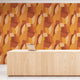 Shades of orange in abstract shapes with a paint brush texture. On wall in an office reception room.