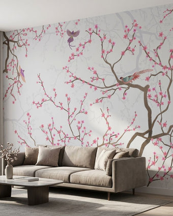 Soft pink floral cherry blossom wall mural in a modern living room, scaled to fit wall proportionally, enhancing the space with subtle color tones.