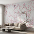 Soft pink floral cherry blossom wall mural in a modern living room, scaled to fit wall proportionally, enhancing the space with subtle color tones.