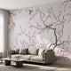 Soft pink floral cherry blossom wall mural in a modern living room, scaled to fit wall proportionally, enhancing the space with subtle color tones.