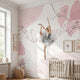 Vertical view of Arabesque Pirouette mural in nursery, with natural light highlighting pink floral ballet motifs and textures.