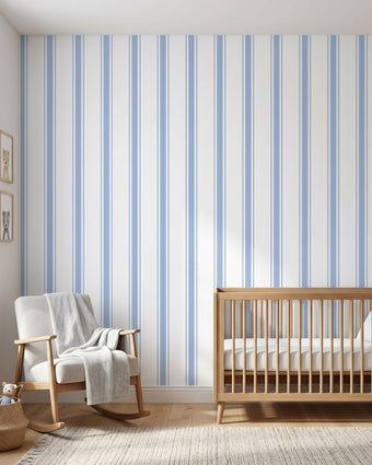 Realistic view of a nursery showcasing a large Baby Blue geometric mural on the wall in natural daylight.