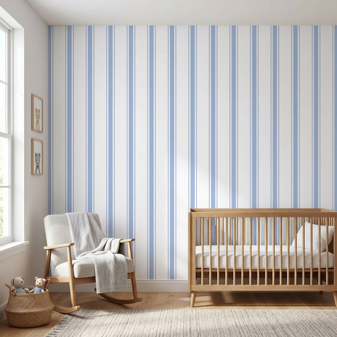 Realistic view of a nursery showcasing a large Baby Blue geometric mural on the wall in natural daylight.
