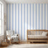 Realistic view of a nursery showcasing a large Baby Blue geometric mural on the wall in natural daylight.