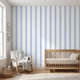 Realistic view of a nursery showcasing a large Baby Blue geometric mural on the wall in natural daylight.