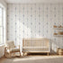 Seamless tulip mural on a large wall in a modern nursery or living room, illuminated by natural sunlight.