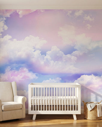 Colorful sky and cloud mural filling a nursery wall edge-to-edge with warm natural lighting, emphasizing its size and vibrant hues.