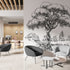 Black and white illustrated mural of a large tree beside a calm river in a peaceful countryside landscape. On a wall in an office seating room. 
