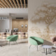 Sepia coloured illustrated mural of a large tree beside a calm river in a peaceful countryside landscape. On an office waiting room wall. 