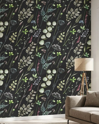 Close-up of the 'On a Whimmmm' seamless floral mural on a textured living room wall, showing vibrant sage green and black patterns with a join-free design.