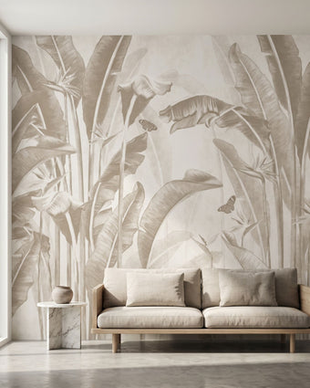 Vibrant overgrown Stralizias floral and butterfly mural covering a large wall in a modern interior with lush greenery and natural daylight.