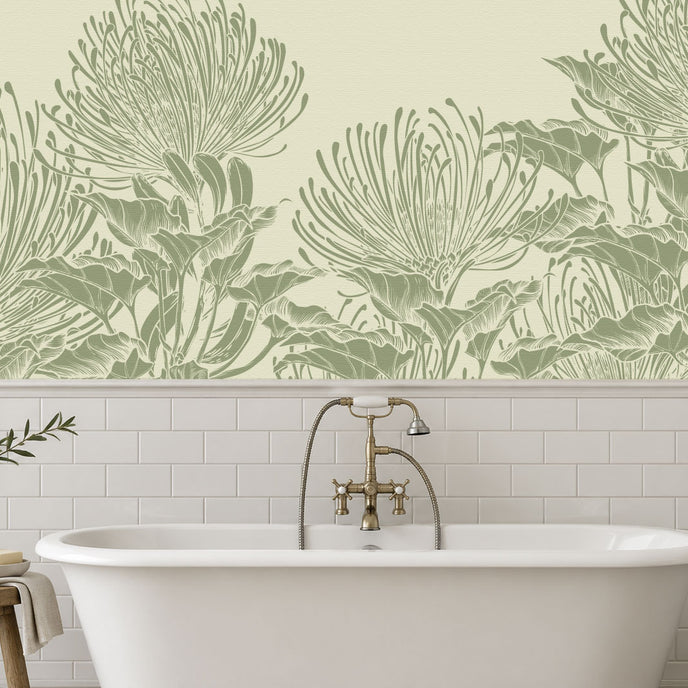 A bathroom scene featuring a white freestanding bathtub with a brass faucet, set against a wall with white subway tiles and a large botanical mural of hand drawn sage green pincushion proteas on a warm ivory background.