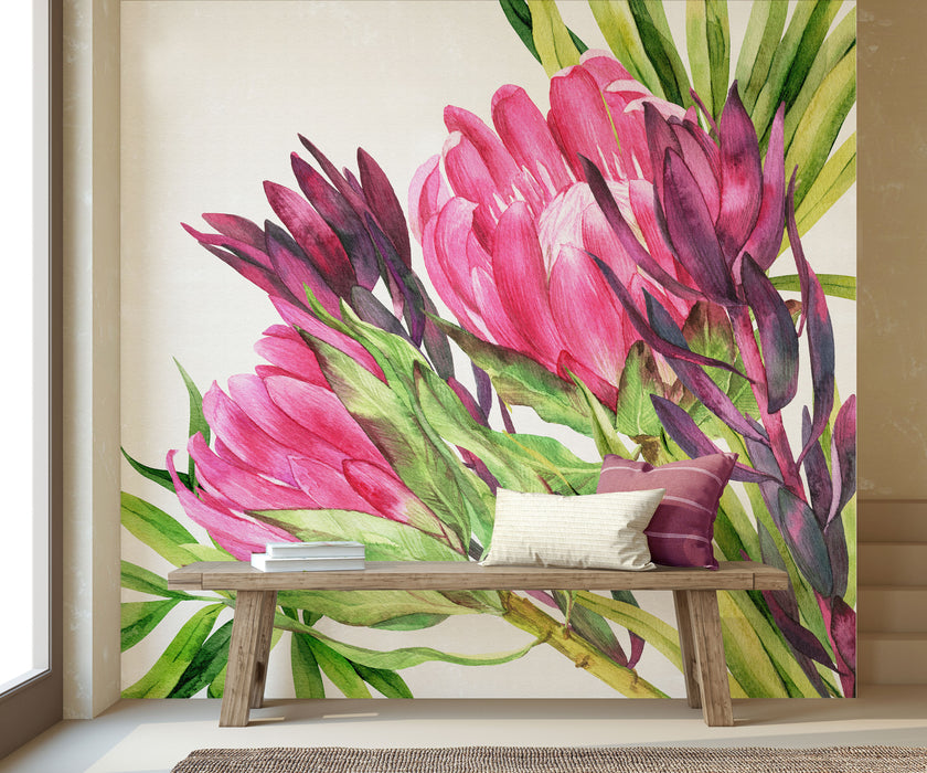 Hand painted watercolour mural featuring vibrant pink proteas with green leaves on a white background. Shown in a styled interior with a wooden bench and pillows.
