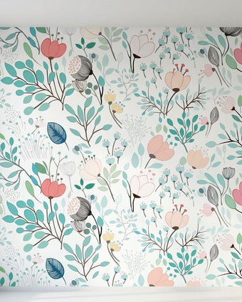 Close-up of SASI Floral mural showcasing vibrant pink, green, and multicoloured floral patterns on textured wall with natural daylight.