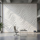 Wide-angle view of a wall mural with a grey and white geometric pattern filling an expansive space with natural lighting.