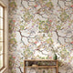 Close-up of 'Spring Renewal' mural featuring multicolored birds and floral patterns on textured living room wall, with natural light highlighting details.