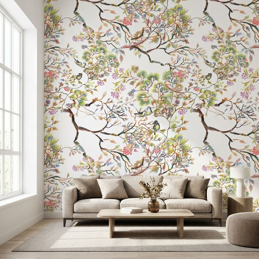Vibrant floral mural with birds and branches in a bright living room setting, showcasing scale and detailed botanical pattern.
