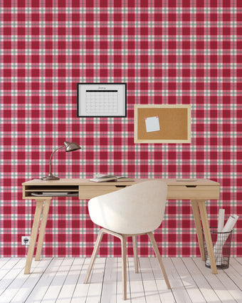 Playful pink tartan wallpaper with layered blush and red tones in a soft check design. On wall of study.
