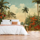 Vintage tropical mural with palm trees, lush green foliage and red orange flowers beneath a soft blue sky, displayed on the wall behind a neatly made bed with white linens and a orange throw blanket, set in a bedroom with wooden flooring.