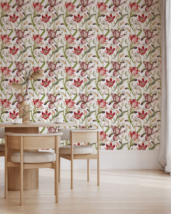 Floral wallpaper featuring hand painted tulips, buds, and delicate blossoms in berry, blush, cream, and soft green tones on a white background, inspired by classic botanical illustrations. This wallpaper is in a dinning room with light wood furniture.