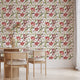 Floral wallpaper featuring hand painted tulips, buds, and delicate blossoms in berry, blush, cream, and soft green tones on a white background, inspired by classic botanical illustrations. This wallpaper is in a dinning room with light wood furniture.