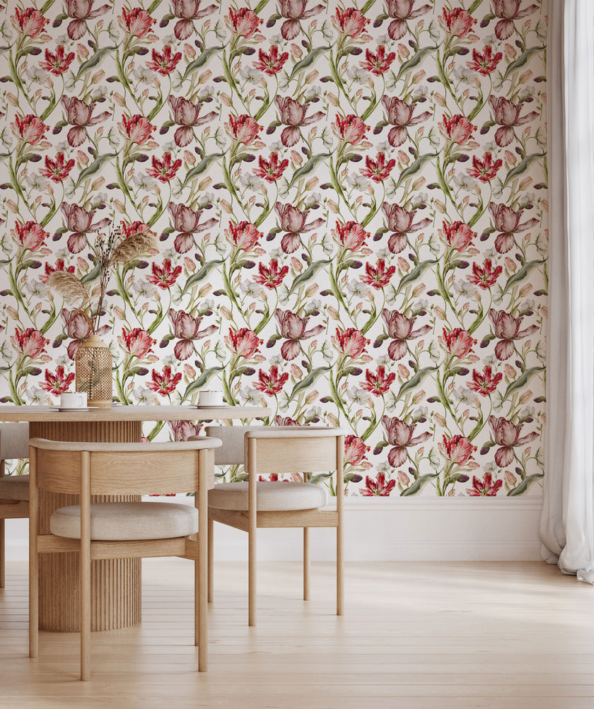 Floral wallpaper featuring hand painted tulips, buds, and delicate blossoms in berry, blush, cream, and soft green tones on a white background, inspired by classic botanical illustrations. This wallpaper is in a dinning room with light wood furniture.