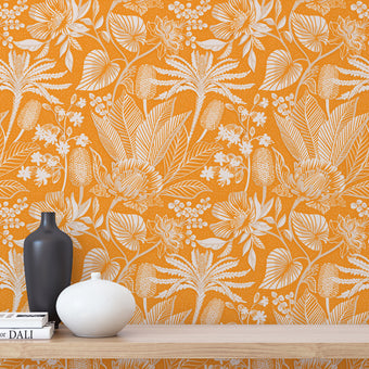 Apricot colour wallpaper with white floral pattern, wooden shelf with decor items.