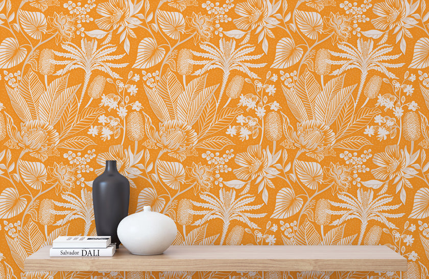 Apricot colour wallpaper with white floral pattern, wooden shelf with decor items.