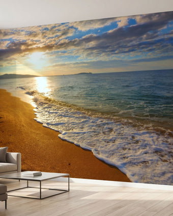 Vibrant beach sunset mural covering a large wall in a modern living room, showcasing colorful sky and calm ocean.