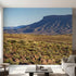 Full-wall mural featuring vibrant mountains, hills, and a tranquil lake, designed to cover entire wall space with natural lighting.