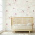 Close-up of 'Where's My Kite?' pink mural with colorful kites in a bright nursery setting, wall-mounted and fully covering the wall.