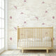 Close-up of 'Where's My Kite?' pink mural with colorful kites in a bright nursery setting, wall-mounted and fully covering the wall.