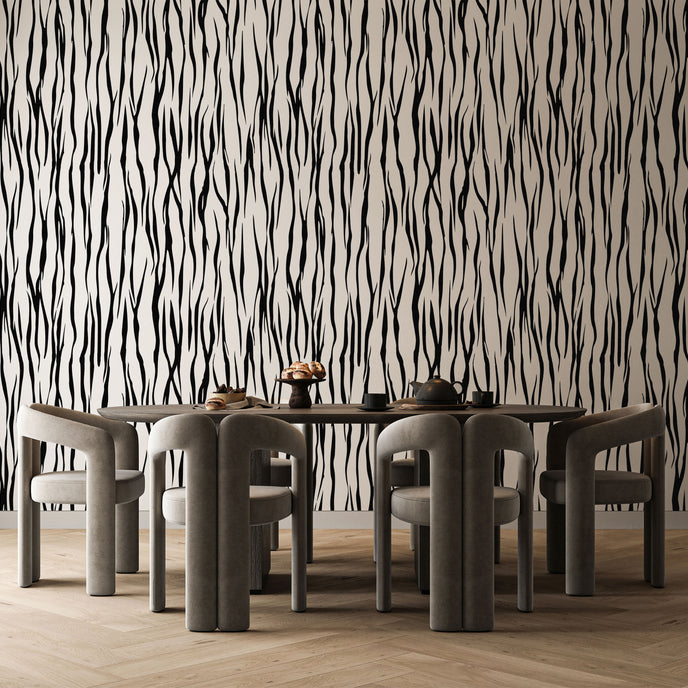 A dining set featuring a rectangular wooden table and six curved grey chairs, set against a bold black and white vertical zebra stripe wallpaper with a seamless repeat, featuring flowing black stripes on a white background in a bold animal inspired pattern, and light wood herringbone flooring.

